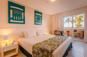 Apartamento Frente Mar Duplo do Hotel Ponta Verde Praia do Francês com cama de casal e varanda voltada para o mar